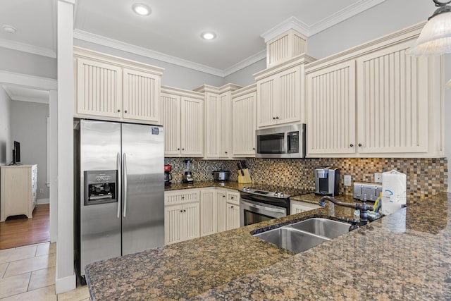 kitchen with crown molding, stainless steel appliances, sink, tasteful backsplash, and light tile flooring