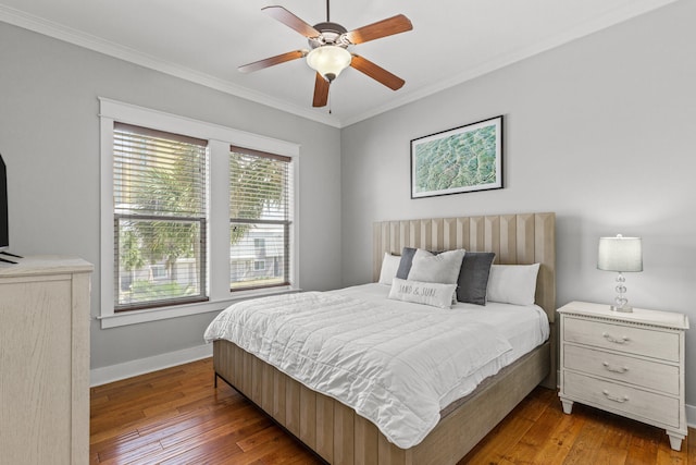 bedroom featuring wood-type flooring, ornamental molding, and ceiling fan