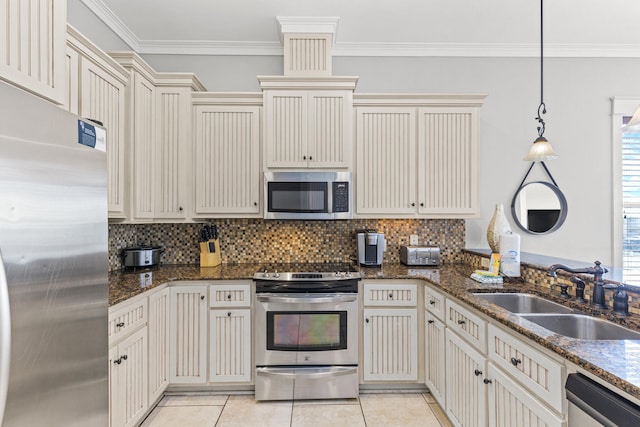 kitchen featuring sink, backsplash, light tile floors, and stainless steel appliances