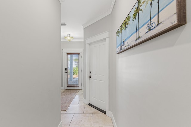 hallway featuring ornamental molding and light tile floors