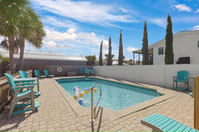 view of swimming pool featuring a patio area