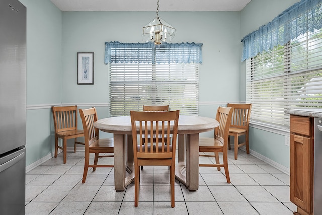 tiled dining space with a notable chandelier and plenty of natural light