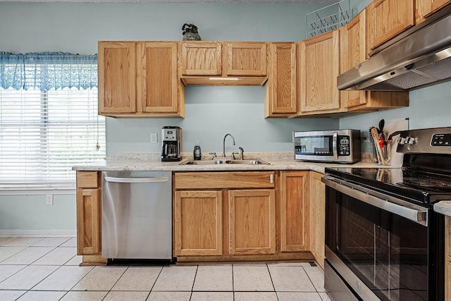 kitchen featuring appliances with stainless steel finishes, sink, and light tile floors