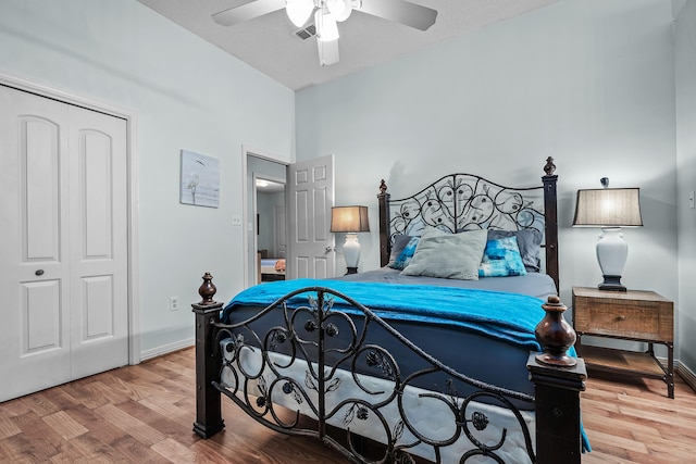 bedroom with a closet, wood-type flooring, and ceiling fan