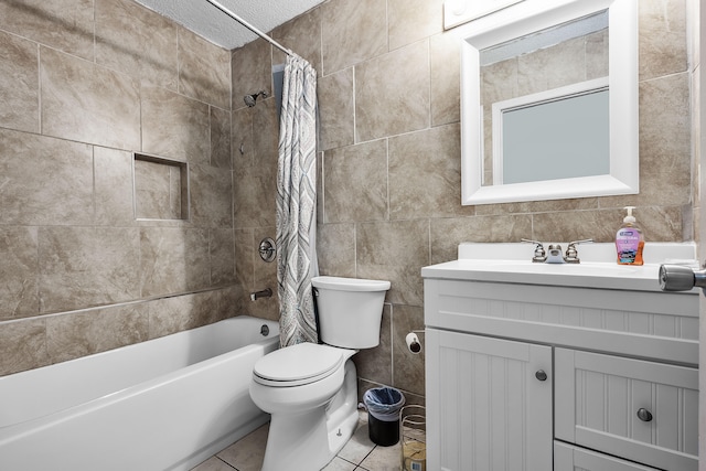 full bathroom featuring tile walls, toilet, tile floors, vanity, and shower / tub combo with curtain