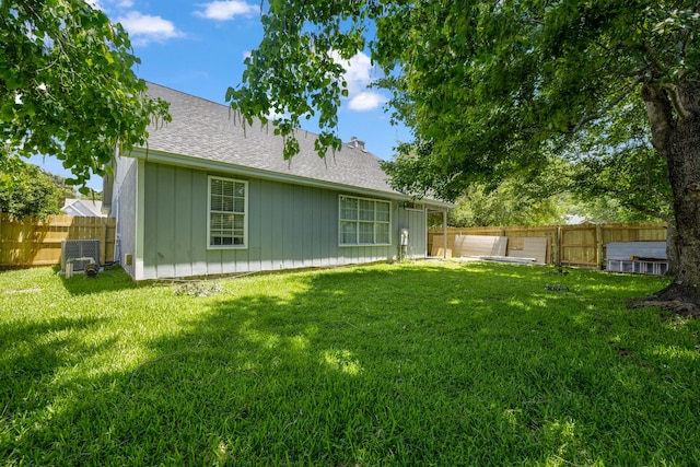 rear view of property with a yard