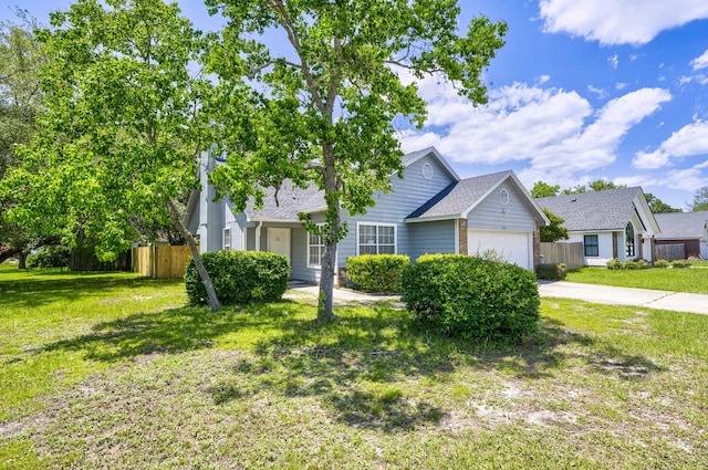 view of front of house featuring a garage and a front lawn