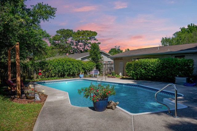 pool at dusk with a patio