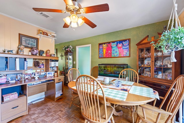 dining room with ceiling fan, built in desk, and parquet flooring