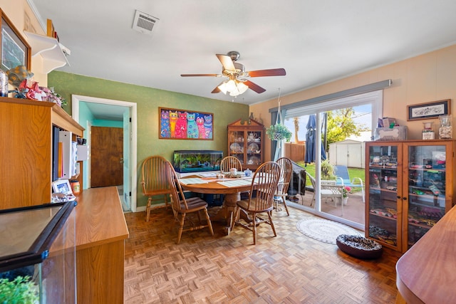 dining room featuring ceiling fan and parquet flooring