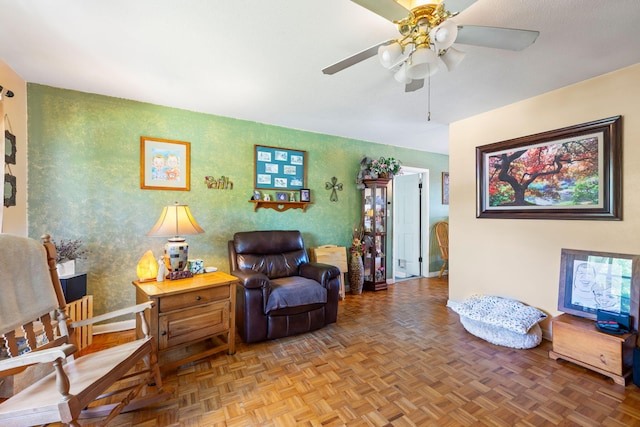 living room with ceiling fan and parquet flooring