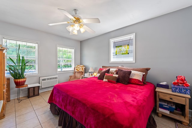 tiled bedroom with an AC wall unit and ceiling fan