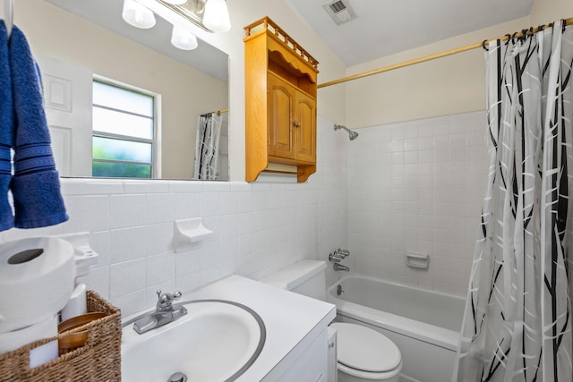 full bathroom featuring shower / tub combo, tile walls, backsplash, vanity, and toilet