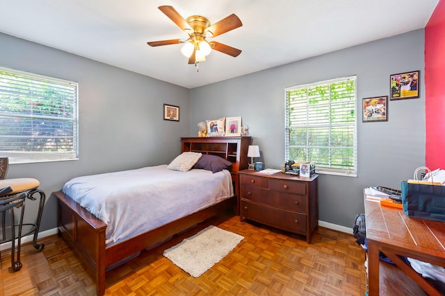 bedroom featuring parquet flooring and ceiling fan