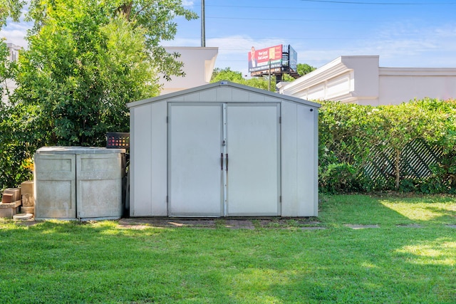 view of outdoor structure featuring a lawn