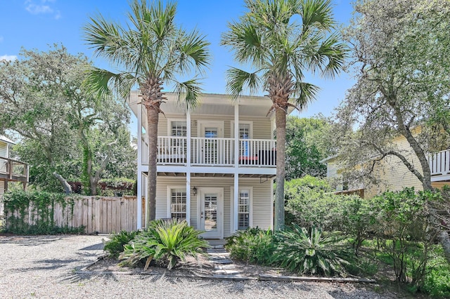 view of front of house with a balcony and french doors