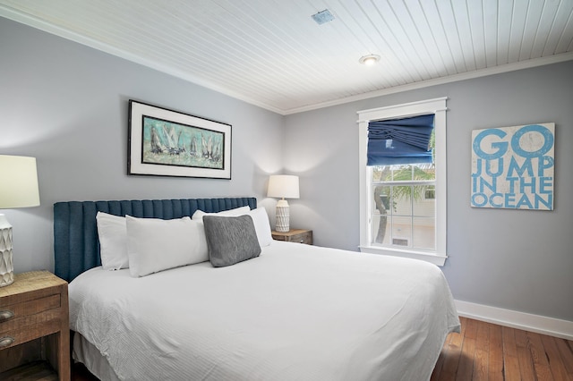 bedroom with dark hardwood / wood-style flooring, wooden ceiling, and ornamental molding