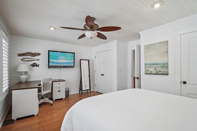 bedroom with hardwood / wood-style floors, ceiling fan, and ornamental molding