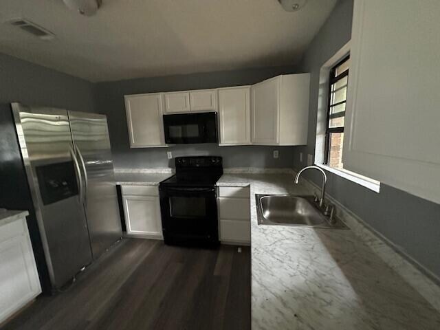 kitchen featuring black appliances, sink, white cabinets, and dark wood-type flooring