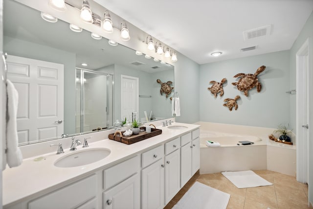 bathroom featuring tile floors, double vanity, and independent shower and bath