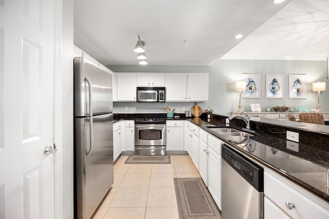 kitchen featuring light tile flooring, crown molding, white cabinets, sink, and appliances with stainless steel finishes