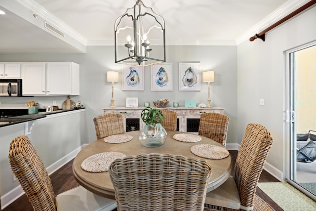 dining space featuring a notable chandelier, ornamental molding, and wood-type flooring