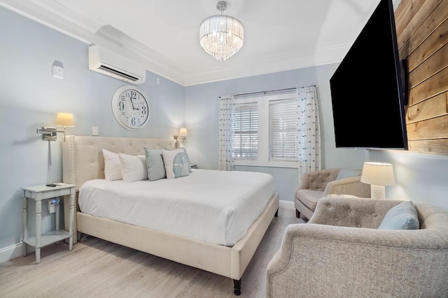 bedroom with a wall unit AC, a chandelier, light wood-type flooring, and crown molding