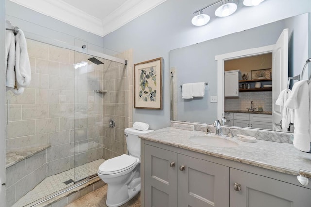 bathroom featuring walk in shower, vanity, toilet, and ornamental molding