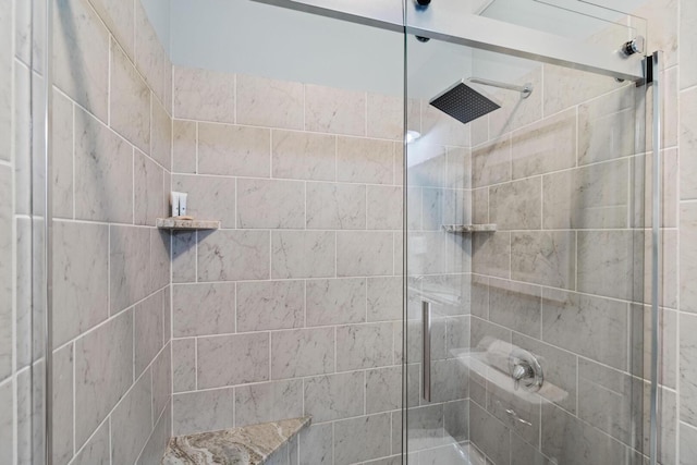 bathroom with a shower with door