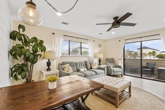 living area featuring light wood-type flooring, visible vents, recessed lighting, and a ceiling fan