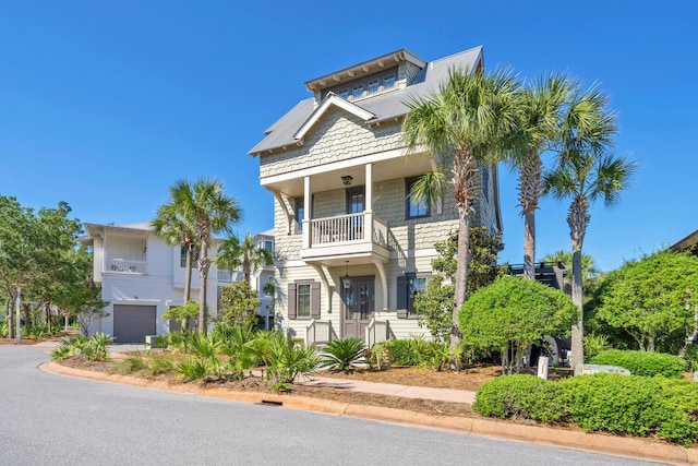 raised beach house with a balcony and a garage