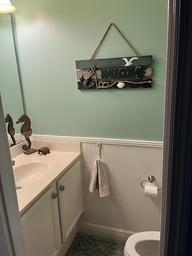 bathroom featuring vanity and toilet