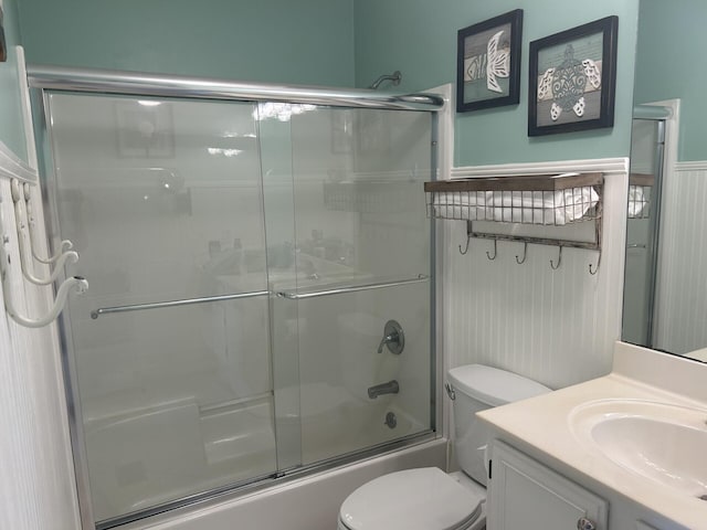 full bathroom featuring vanity, toilet, and enclosed tub / shower combo