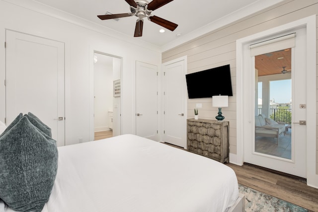 bedroom with access to exterior, ensuite bath, ornamental molding, ceiling fan, and hardwood / wood-style floors