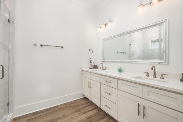 bathroom with crown molding, a shower with door, vanity, and hardwood / wood-style flooring