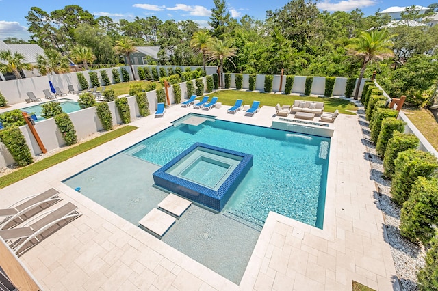 view of pool featuring an in ground hot tub and a patio