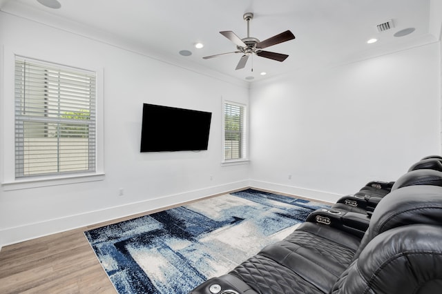 living room with ceiling fan, wood-type flooring, and ornamental molding