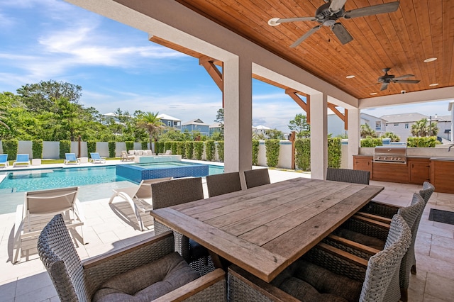 view of patio featuring ceiling fan, a pool with hot tub, area for grilling, and grilling area