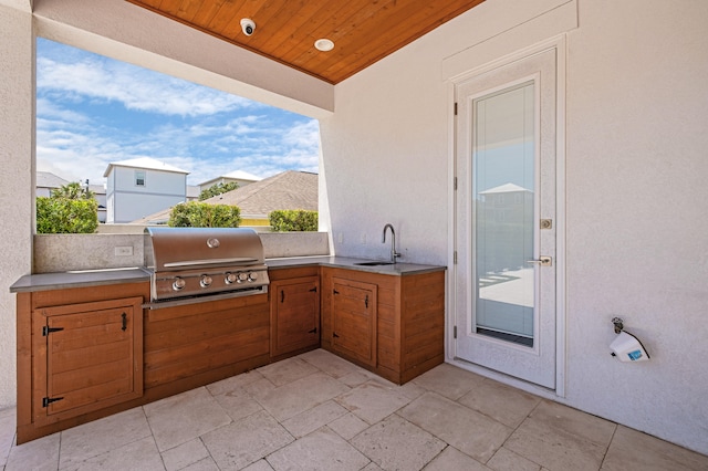 view of patio with an outdoor kitchen, a grill, and sink