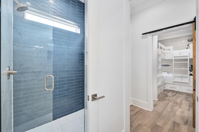 bathroom featuring hardwood / wood-style flooring and an enclosed shower