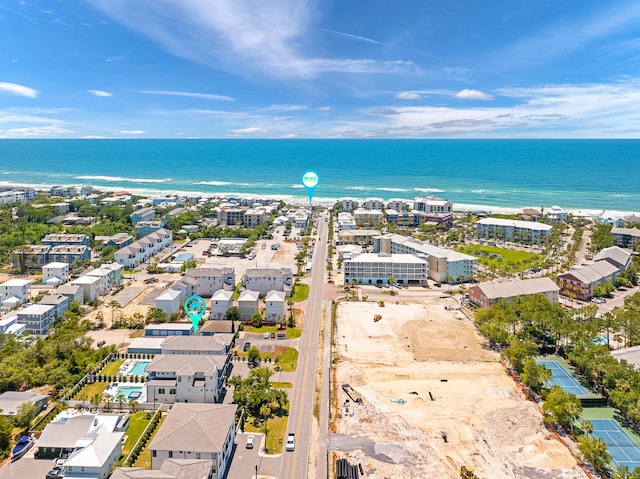 bird's eye view featuring a water view and a beach view