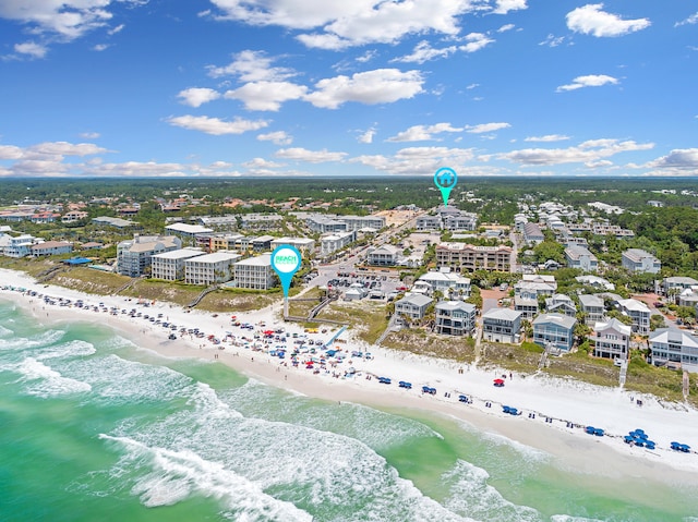 birds eye view of property with a water view and a view of the beach