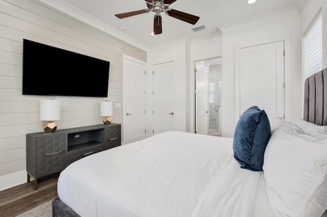 bedroom with dark hardwood / wood-style flooring, ensuite bathroom, ceiling fan, and crown molding