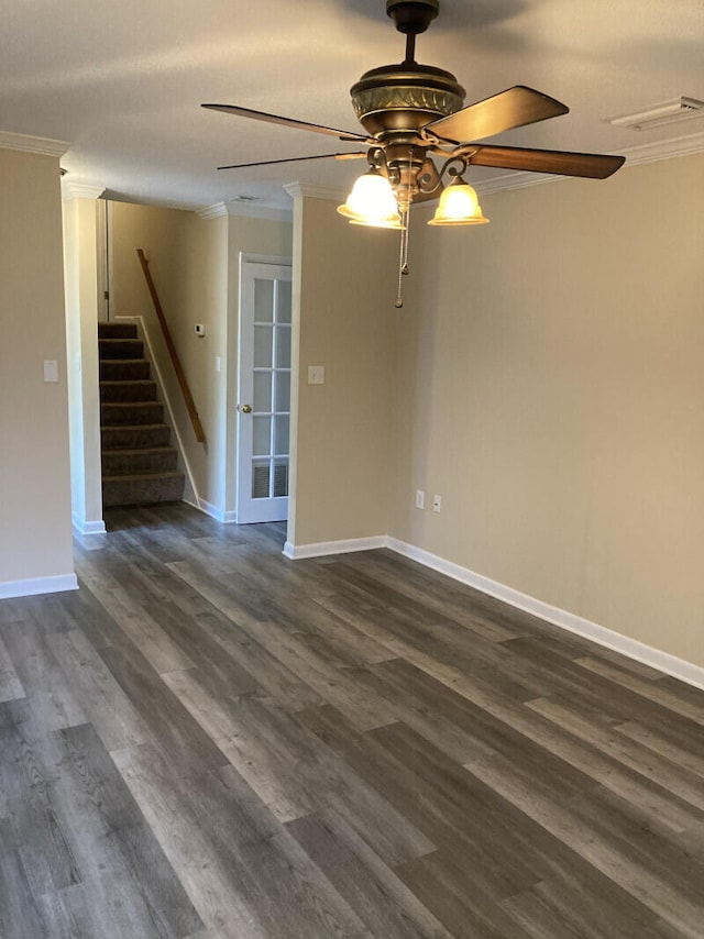 empty room with ornamental molding, ceiling fan, and dark hardwood / wood-style floors