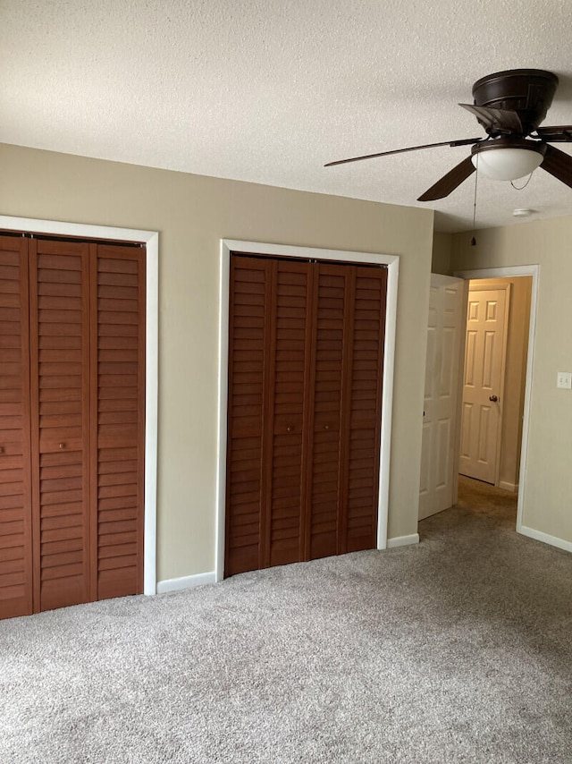 unfurnished bedroom with carpet, ceiling fan, and a textured ceiling