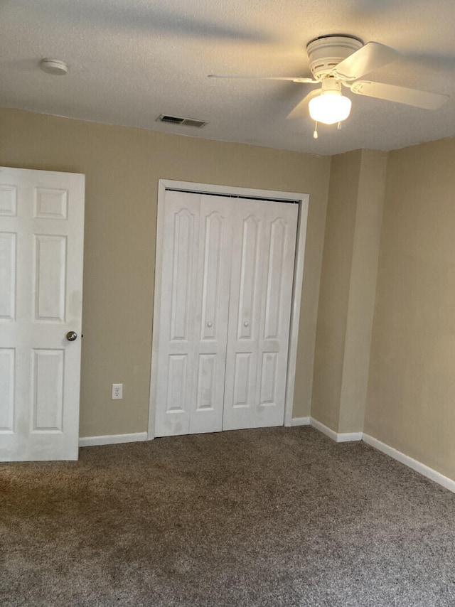 unfurnished bedroom with carpet flooring, a closet, and ceiling fan