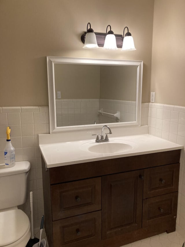 bathroom featuring tile flooring, toilet, tile walls, backsplash, and oversized vanity