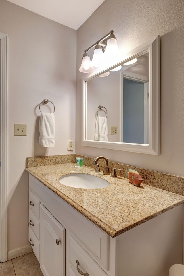 bathroom featuring tile patterned flooring and vanity