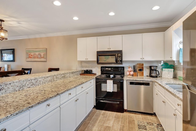 kitchen with pendant lighting, black appliances, white cabinets, decorative backsplash, and ornamental molding