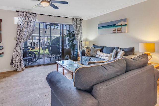 living room with ceiling fan and crown molding